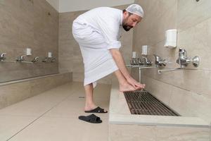 A Muslim takes ablution for prayer. Islamic religious rite photo