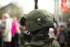 Helmet of Russian soldier. Military helmet on his head. Protective means against shot. photo