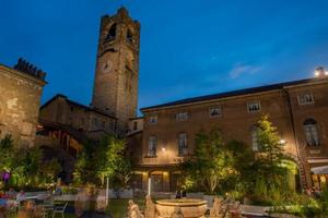 Bergamo old square with fountain and bell tower photo