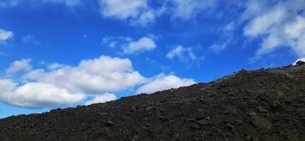 The sky is clear and blue at noon. The photo was taken on a hill.