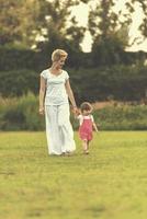 mother and little daughter playing at backyard photo