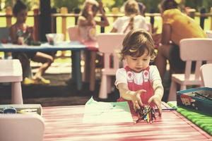 little girl drawing a colorful pictures photo