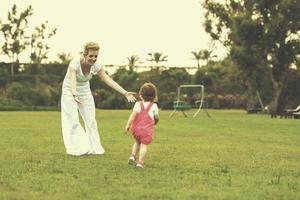 mother and little daughter playing at backyard photo