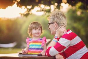 mom and her little daughter using tablet computer photo