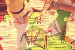 mom and little daughter drawing a colorful pictures photo