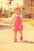 little girl runing in the summer Park photo