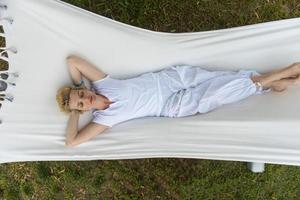 young woman resting on hammock photo