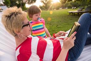 mom and a little daughter relaxing in a hammock photo