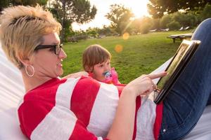 mom and a little daughter relaxing in a hammock photo