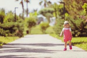 little girl runing in the summer Park photo