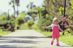 little girl runing in the summer Park photo