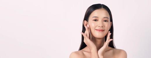 Beautiful young asian woman with clean fresh skin on white background. photo