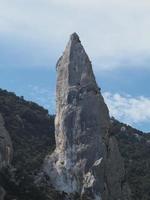 climber on Goloritze rock cliff by the sea Sardinia Italy photo