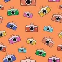 Seamless pattern with hand drawn colorful cameras doodle style, vector illustration on orange background. Bright design for packaging and wrapping, print and web