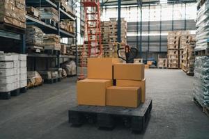 Forklifts for transporting goods in industrial warehouse storage of retail shop. Warehouse interior with shelves rack for keep production material, pallets and boxes. Industrial concept. photo