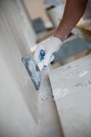 construction worker plastering on gypsum walls photo