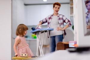 mother and little daughter spending time together at home photo