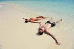 happy young couple have fun on beach photo