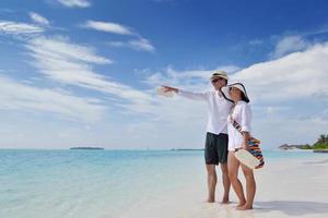 happy young couple have fun on beach photo