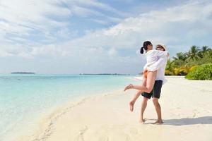 happy young couple have fun on beach photo