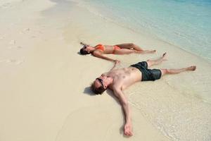 happy young couple have fun on beach photo