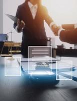 Justice and law concept.Male judge in a courtroom with the gavel, working with, computer and docking keyboard, eyeglasses, on table in morning light photo