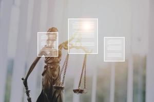 Justice and law concept.Male judge in a courtroom with the gavel, working with, computer and docking keyboard, eyeglasses, on table in morning light photo