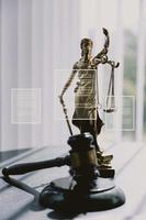 Justice and law concept.Male judge in a courtroom with the gavel, working with, computer and docking keyboard, eyeglasses, on table in morning light photo