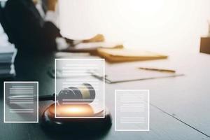 Justice and law concept.Male judge in a courtroom with the gavel, working with, computer and docking keyboard, eyeglasses, on table in morning light photo