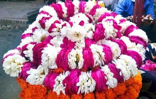 Top view of rolled up garlands of white and pink flowers in a flower shop photo