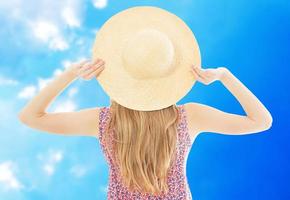 Back view Woman in hat relaxing at blue sky background photo