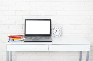 Education accessories on the table near brick wall. Empty computer and mobile screen with place for text. photo