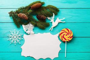 Christmas accessories with card and copy space on blue wooden background photo