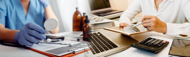 Medicine doctor hand working on a patients x-ray scans digital healthcare and connection with modern virtual screen interface icons, Medical technology and network concept. photo
