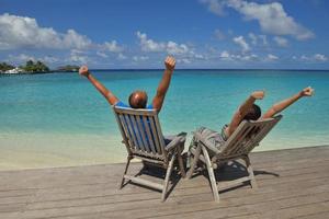 happy young couple have fun on beach photo