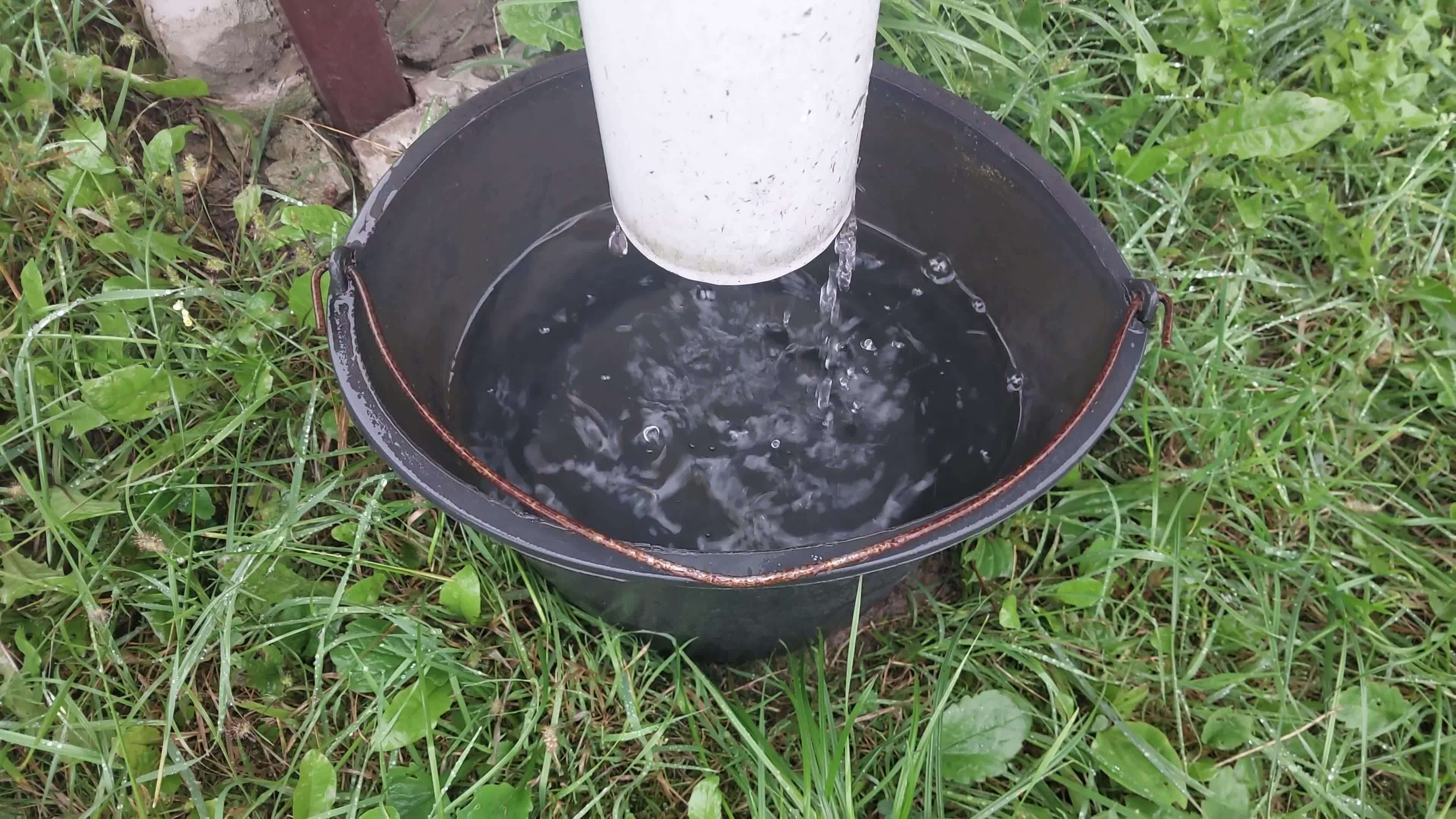 Rainwater dripping from a drain into a bucket 11961953 Stock Video at