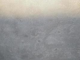 Old Wall damaged with blown Plaster and paint clog,peeling paint damage,water damage on building wall.Grunge abstract background.Wall fragment with scratches and cracks.Old distressed wall backdrop. photo