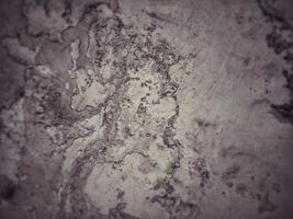 Old Wall damaged with blown Plaster and paint clog,peeling paint damage,water damage on building wall.Grunge abstract background.Wall fragment with scratches and cracks.Old distressed wall backdrop. photo