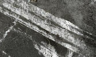 Old Wall damaged with blown Plaster and paint clog,peeling paint damage,water damage on building wall.Grunge abstract background.Wall fragment with scratches and cracks.Old distressed wall backdrop. photo