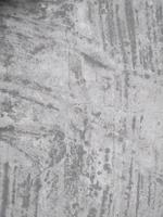Old Wall damaged with blown Plaster and paint clog,peeling paint damage,water damage on building wall.Grunge abstract background.Wall fragment with scratches and cracks.Old distressed wall backdrop. photo