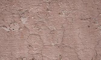 Old Wall damaged with blown Plaster and paint clog,peeling paint damage,water damage on building wall.Grunge abstract background.Wall fragment with scratches and cracks.Old distressed wall backdrop. photo