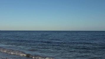 Cargo ships passing by on the baltic sea water at the world war monument in Laboe Germany video