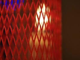 Christmas candles on the table inside red platic net photo