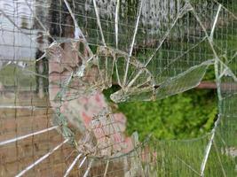 gun bullet broken window glass photo