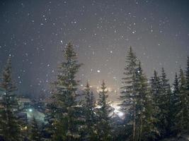 snowing at night in dolomites mountains photo