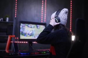 Young female professional Streamer and gamer with headset playing online video games photo