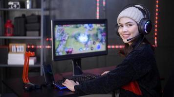 Young female professional Streamer and gamer with headset playing online video games photo