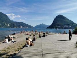 LUGANO, SWITZERLAND - JUNE 23 2019 - Lugano view cityscape from the lake full of people photo