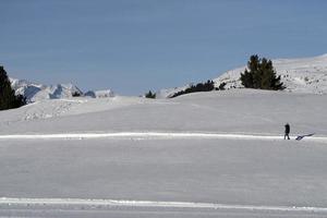 hiker contemplating dolomites mountains in winter photo