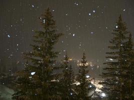 snowing at night in dolomites mountains photo